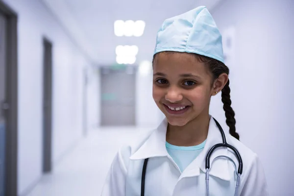 Smiling girl pretending to be a doctor — Stock Photo, Image