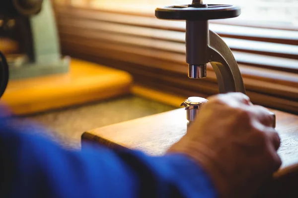 Hand of horologist using a microscope — Stock Photo, Image