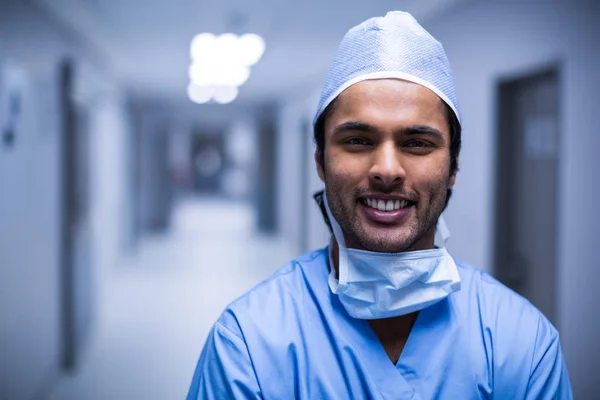 Chirurgo maschio sorridente in piedi in corridoio — Foto Stock