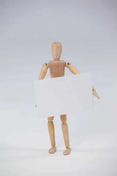Wooden figurine holding a placard — Stock Photo, Image