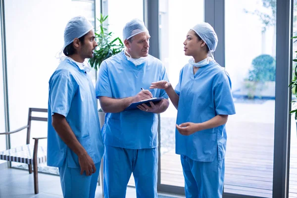 Surgeons discussing over medical reports — Stock Photo, Image