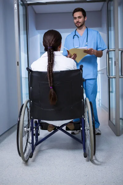 Female doctor sitting on wheelchair — Stock Photo, Image