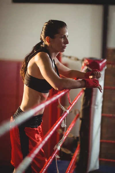 Female boxer standing in boxing ring — Stock Photo, Image