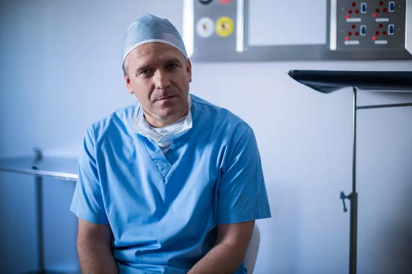 Male surgeon sitting on a chair — Stock Photo, Image