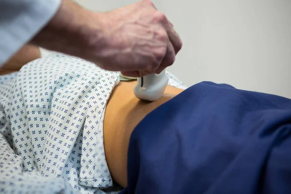 Doctors performing a doppler sonography on patient — Stock Photo, Image