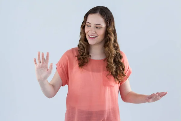 Woman pretending to touch an invisible screen — Stock Photo, Image