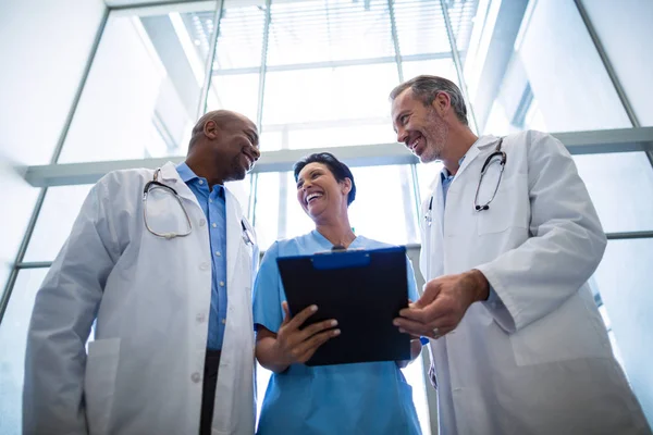 Surgeons and nurse interacting with each other — Stock Photo, Image