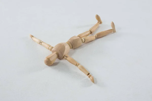 Wooden figurine lying — Stock Photo, Image