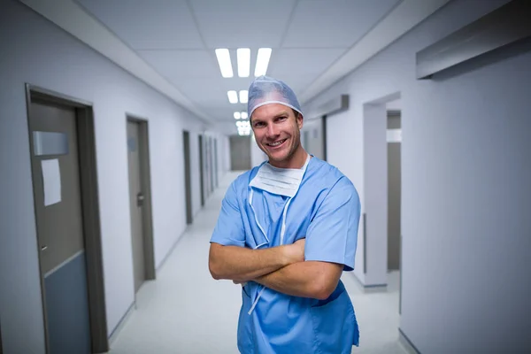 Male nurse standing in corridor Stock Photo