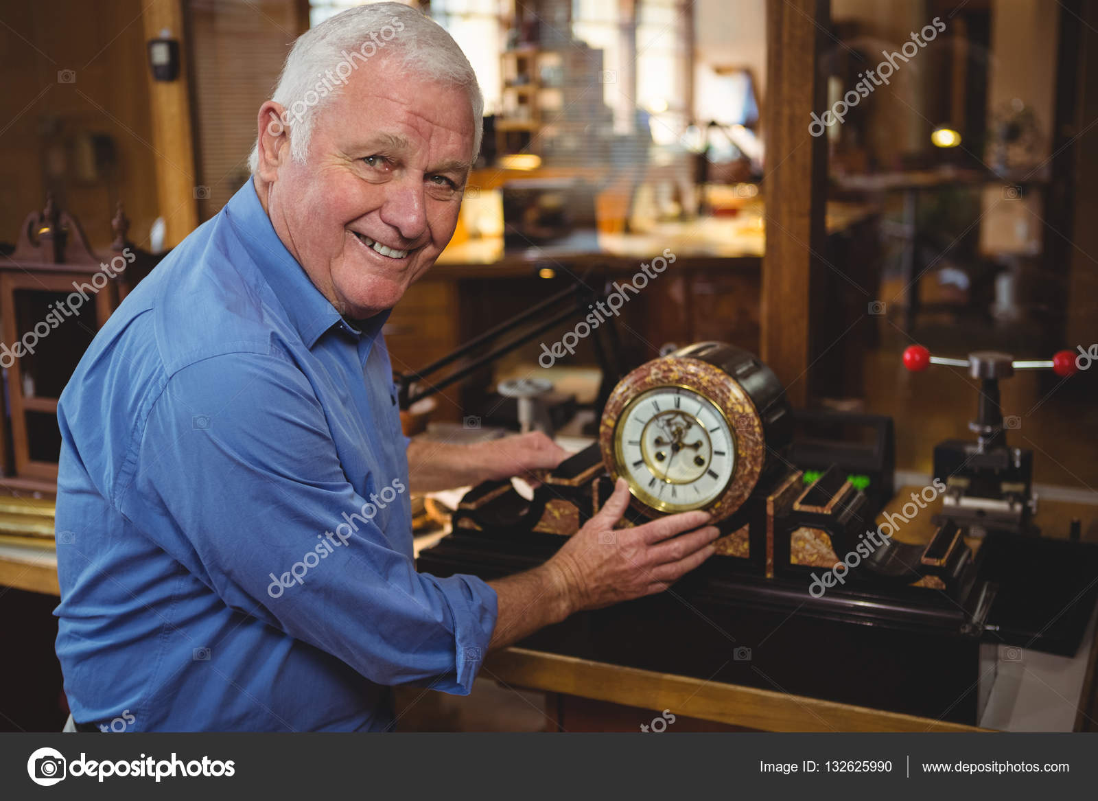 Horologist checking a clock in — Stock Photo © Wavebreakmedia