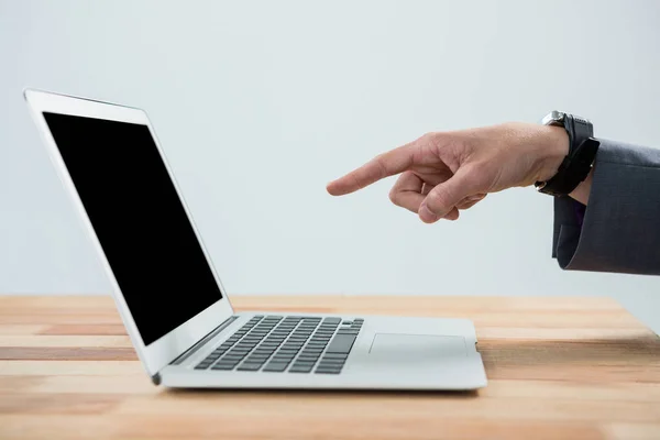 Businessman pointing at laptop — Stock Photo, Image