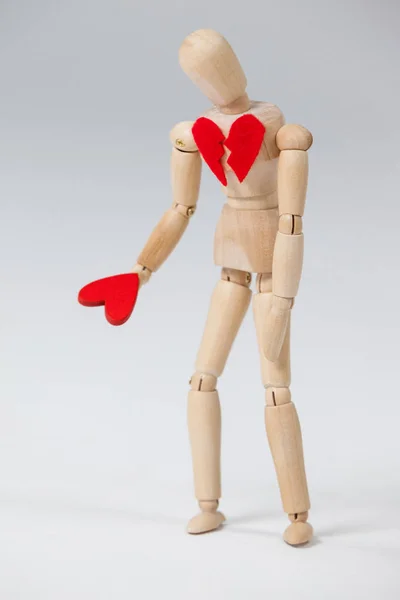 Wooden figurine with a broken heart — Stock Photo, Image