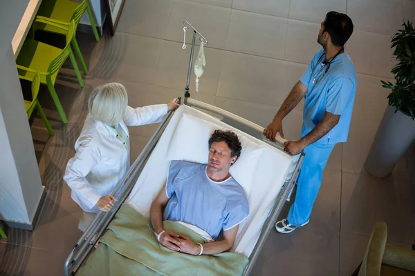 Doctors pushing emergency stretcher bed — Stock Photo, Image