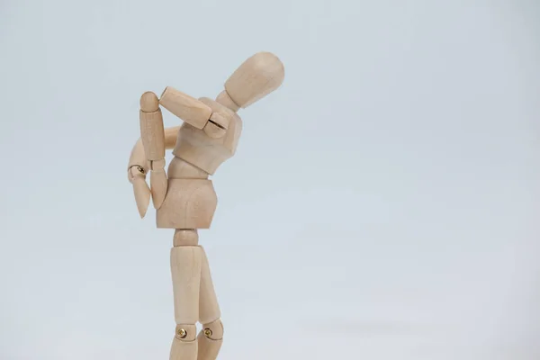 Wooden figurine with hands on back — Stock Photo, Image