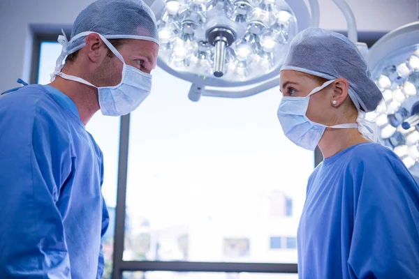 Surgeons interacting with each other — Stock Photo, Image