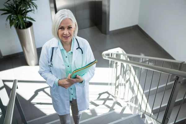 Доктор, стоящий с документами в больнице — стоковое фото