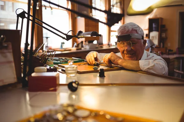 Horologist repairing watch in workshop