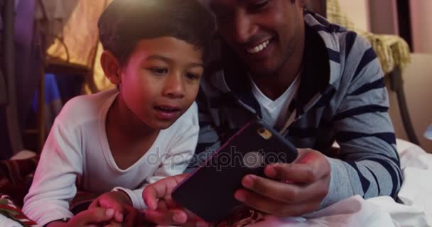 Father and son using mobile phone — Stock Video