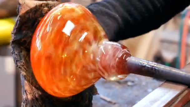 Glassblowers shaping a molten glass — Stock Video