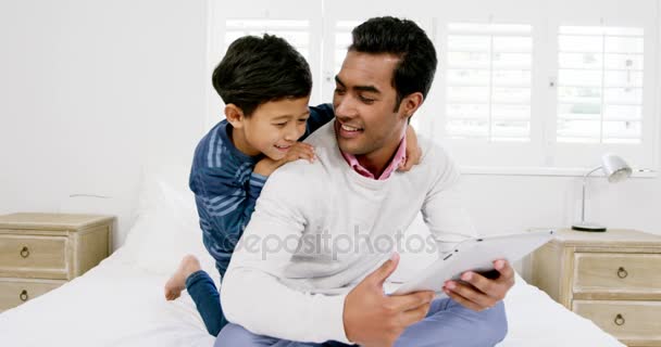 Father and son using digital tablet — Stock Video