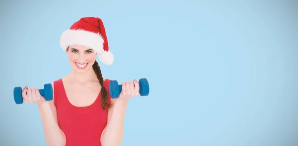 Festive fit brunette holding dumbbells — Stock Photo, Image