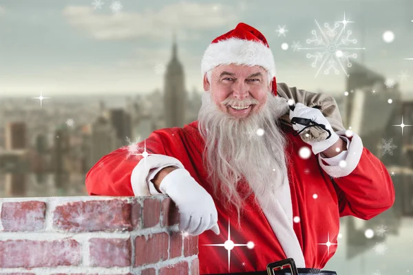 Santa Claus carrying bag full of gifts — Stock Photo, Image