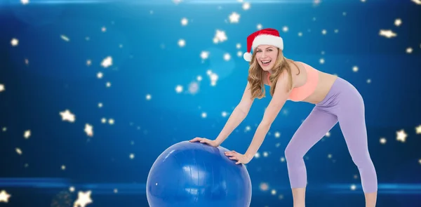 Festive blonde woman using exercise ball — Stock Photo, Image