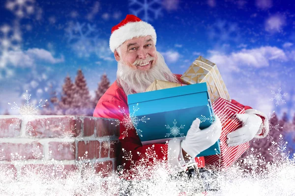 Santa Claus carrying various gifts — Stock Photo, Image