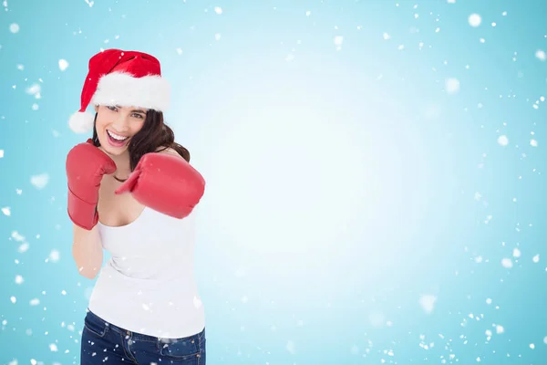 Brunette in boxing gloves punching — Stock Photo, Image