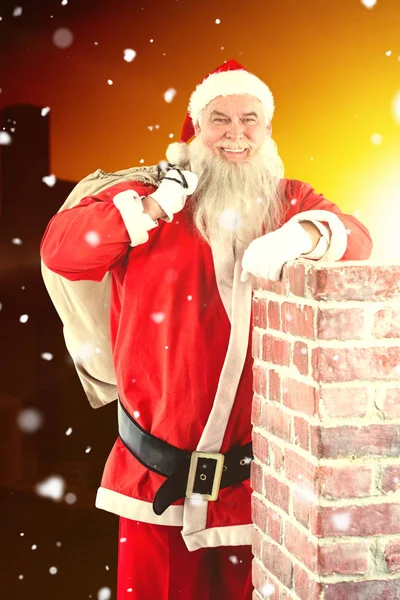 Santa Claus carrying bag full of gifts — Stock Photo, Image