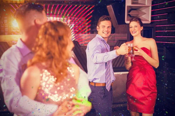 Couple interacting with friends while dancing — Stock Photo, Image