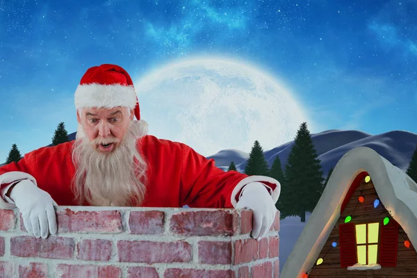 Santa claus gluren over muur — Stockfoto