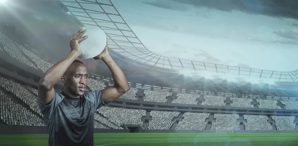 Confident sportsman throwing rugby ball — Stock Photo, Image