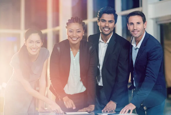 Businesspeople discussing together over tablet — Stock Photo, Image