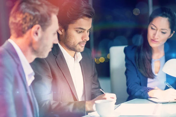 Group of businesspeople looking at document — Stock Photo, Image