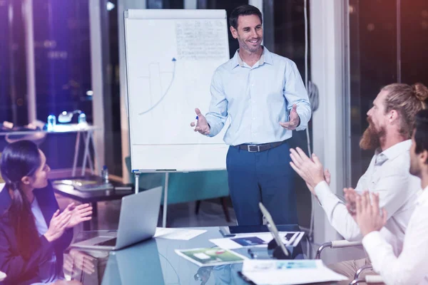Coworkers applauding colleague at presentation — Stock Photo, Image
