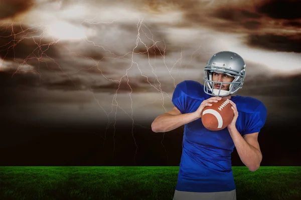 American football player holding ball