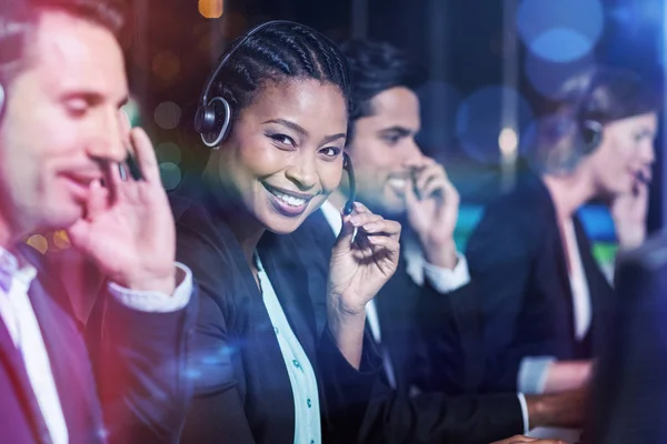 Compañeros felices con auriculares en la oficina —  Fotos de Stock