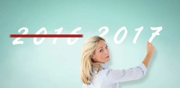 Teacher writing against blue background — Stock Photo, Image