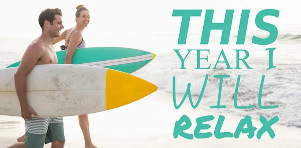 Couple with surfboards running on beach — Stock Photo, Image