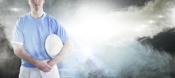 Rugby player handing a rugby ball — Stock Photo, Image
