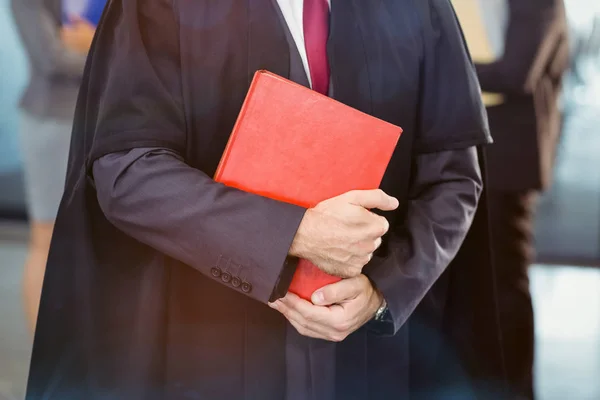 Midsection of lawyer holding law book — Stock Photo, Image