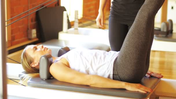 Entrenadora que ayuda a la mujer con el ejercicio — Vídeos de Stock