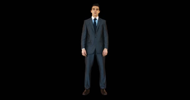 Uomo d'affari in piedi contro sfondo nero — Video Stock