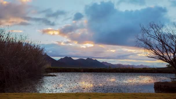 Time lapse of clouds over lake — Stock Video