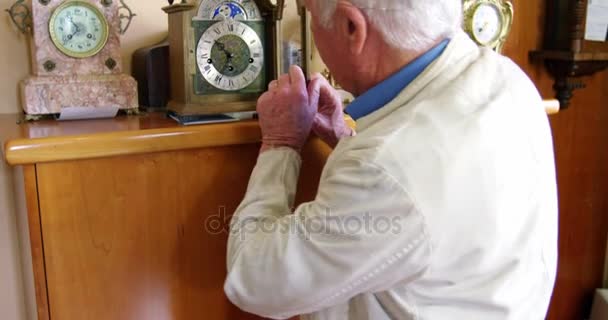 Portrait of smiling horologist adjusting watch — Stock Video