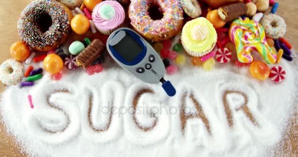 Doughnuts and cupcakes with glucometer — Stock Video