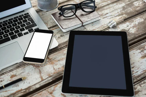 Close-up of digital tablet with mobile phone and laptop — Stock Photo, Image