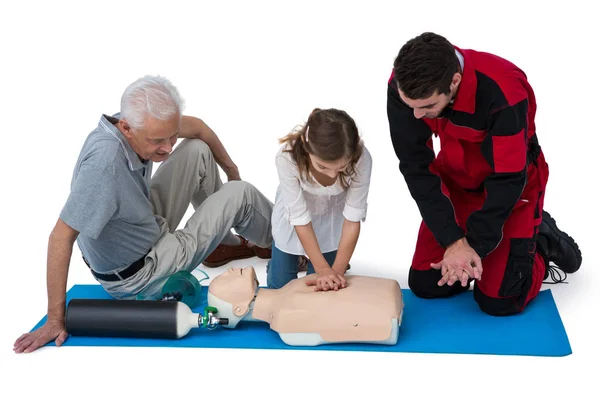 Paramedic training cardiopulmonary resuscitation to man and girl — Stock Photo, Image