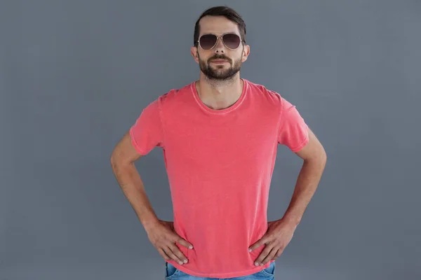 man in pink t-shirt and sunglasses